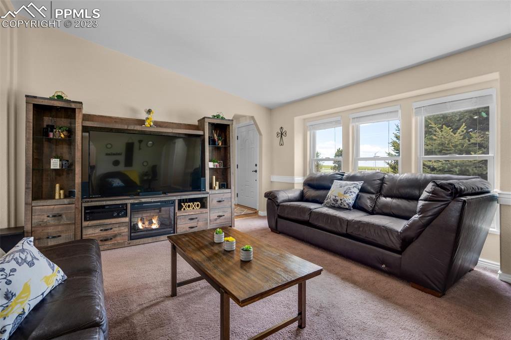 28230 Washington Road Calhan, CO 80808 - Photo 7 of 40 a living room with furniture a flat screen tv and a window