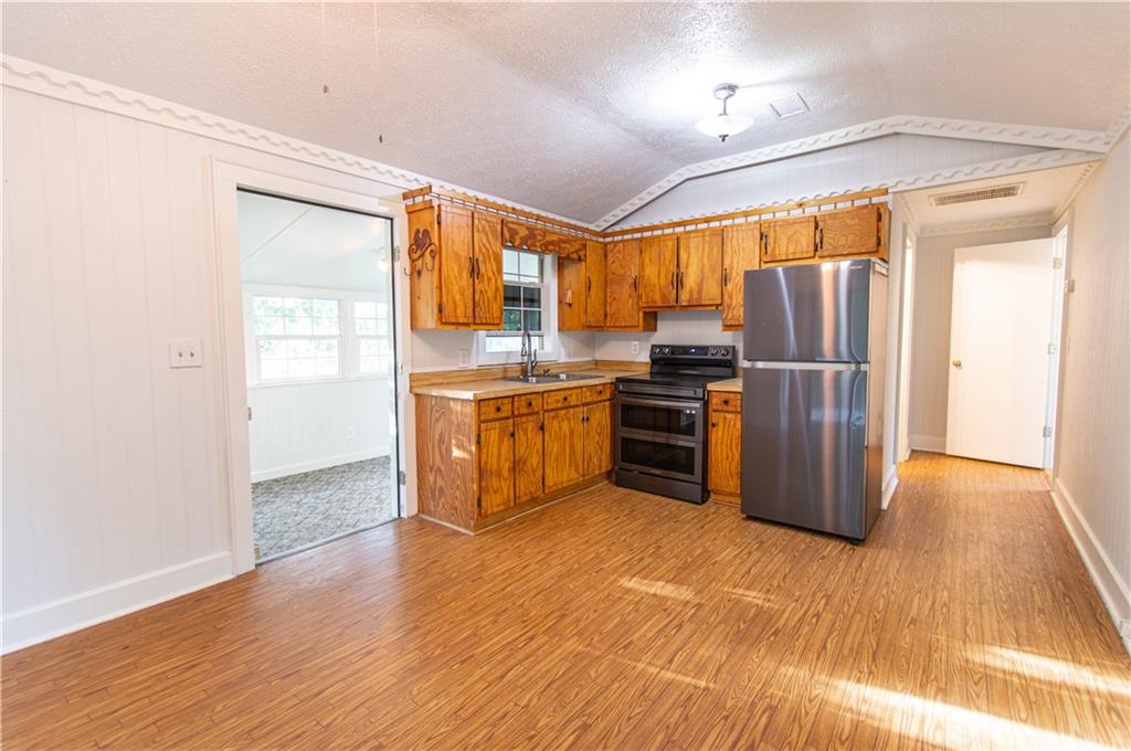 250 Nottingham Way Fairmount, GA 30139 - Photo 15 of 43 a kitchen with stainless steel appliances granite countertop a refrigerator a sink a stove and island