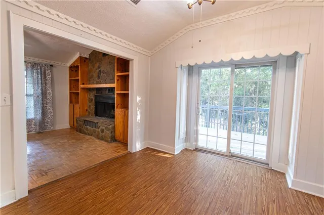 a view of empty room with wooden floor and cabinet