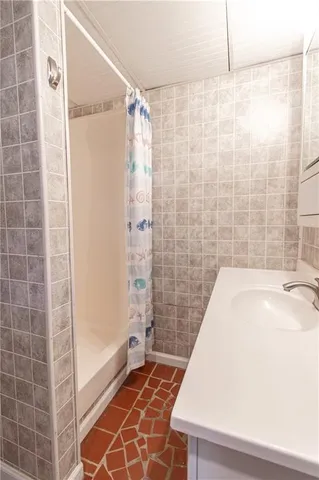 a view of a hallway with wooden floor and a window