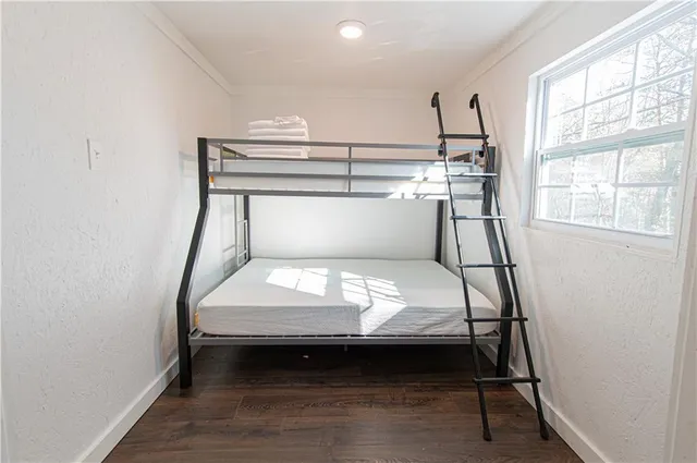 a bedroom with furniture and a window