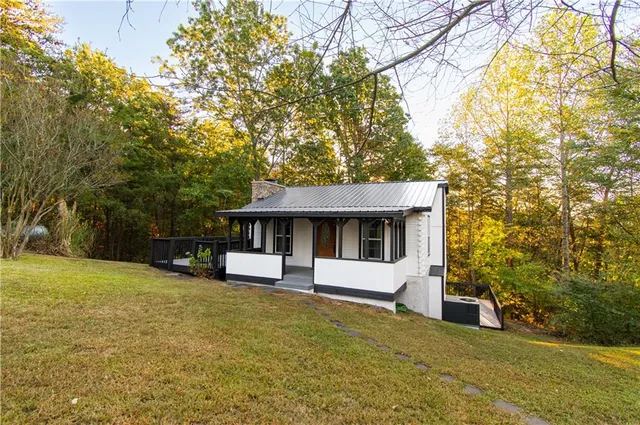 a front view of a house with yard and trees