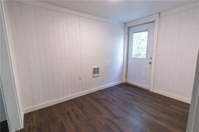 a balcony with wooden floor and trees
