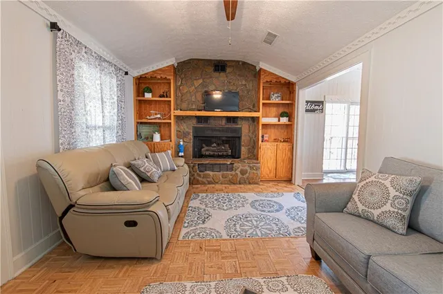a living room with furniture and a fireplace