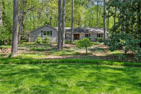 a front view of a house with yard and green space