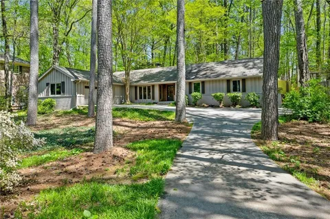 a view of a house with a tree in front of it