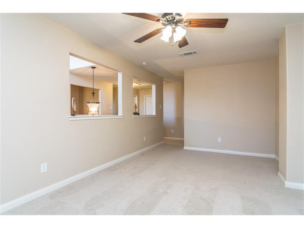 1009 Hawthorne Road Anna, TX 75409 - Photo 13 of 22 Carpeted living space with neutral tone walls