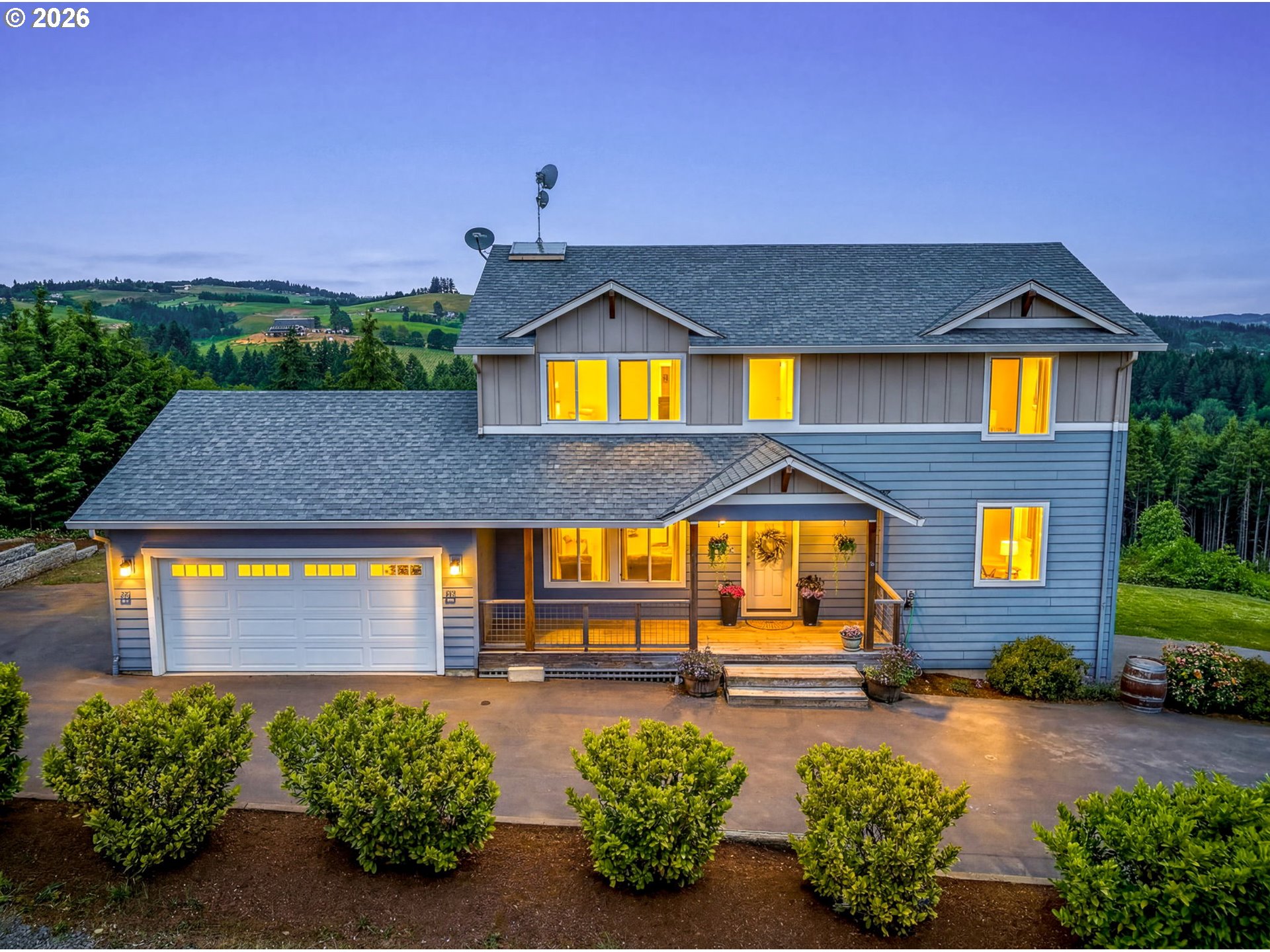 a front view of a house with a yard and outdoor seating