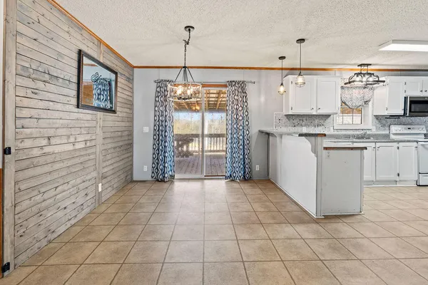 a kitchen with stainless steel appliances granite countertop a stove a sink and white cabinets