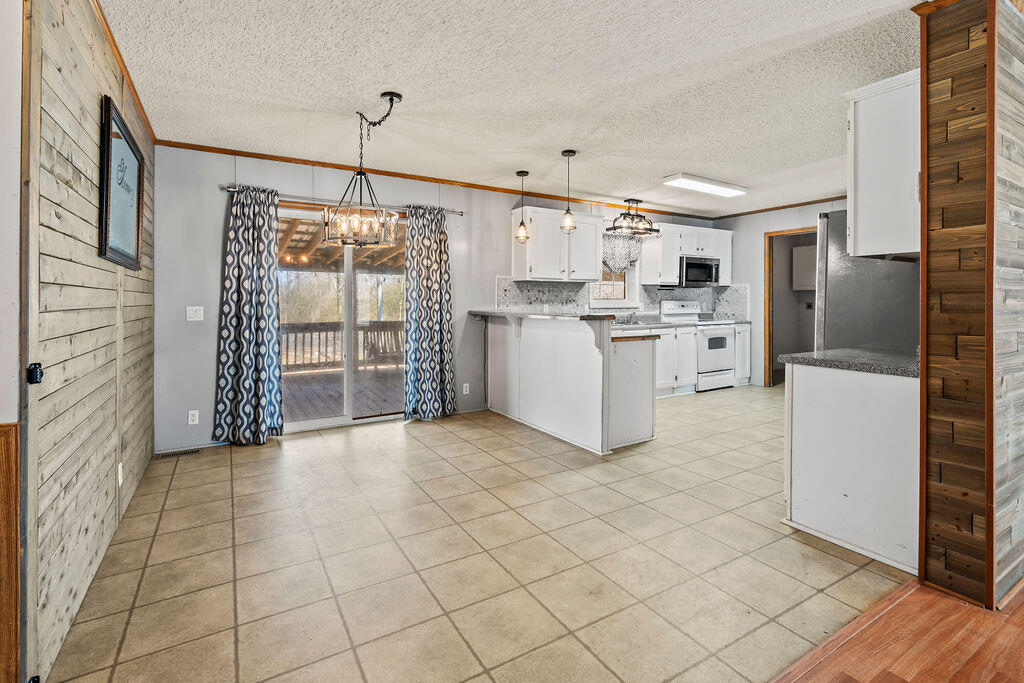 18097 Country Cross Road Florala, AL 36442 - Photo 19 of 32 a open kitchen with cabinets and stainless steel appliances