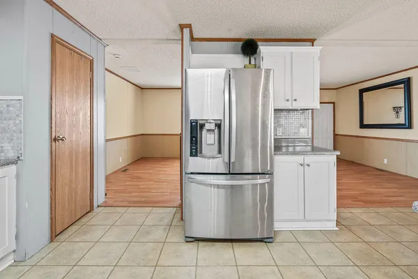 a kitchen with cabinets and stainless steel appliances