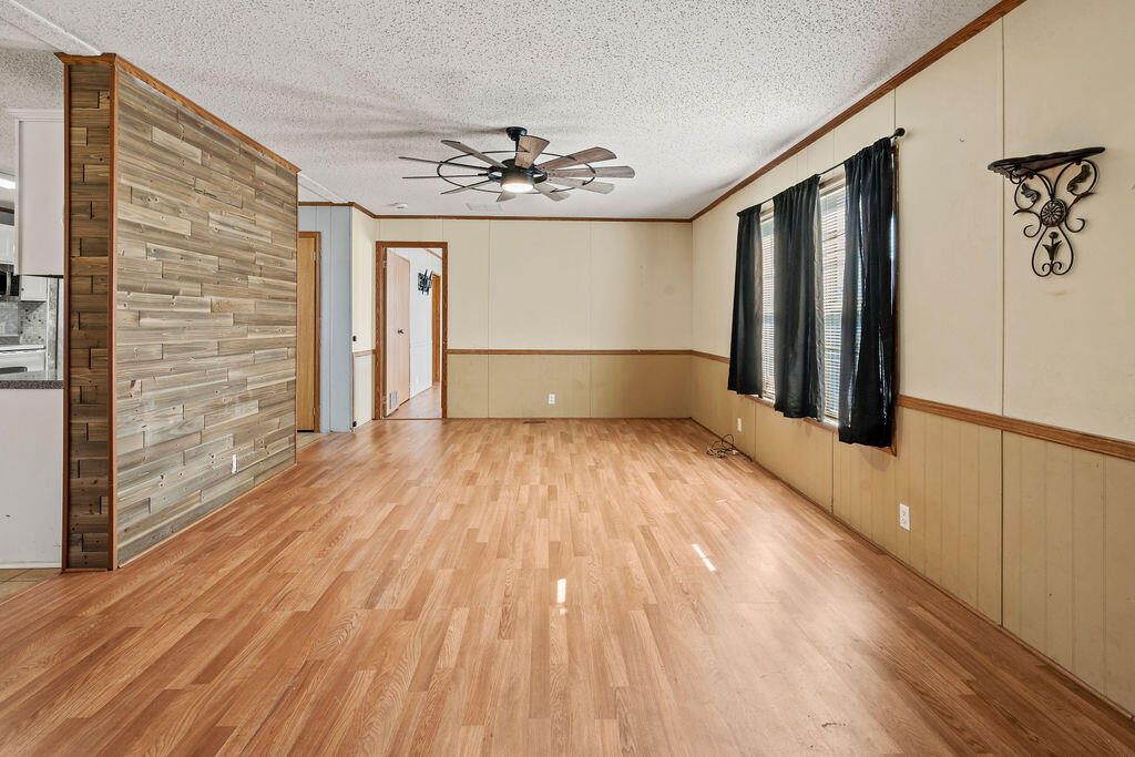 18097 Country Cross Road Florala, AL 36442 - Photo 25 of 32 a view of empty room with wooden floor and fan