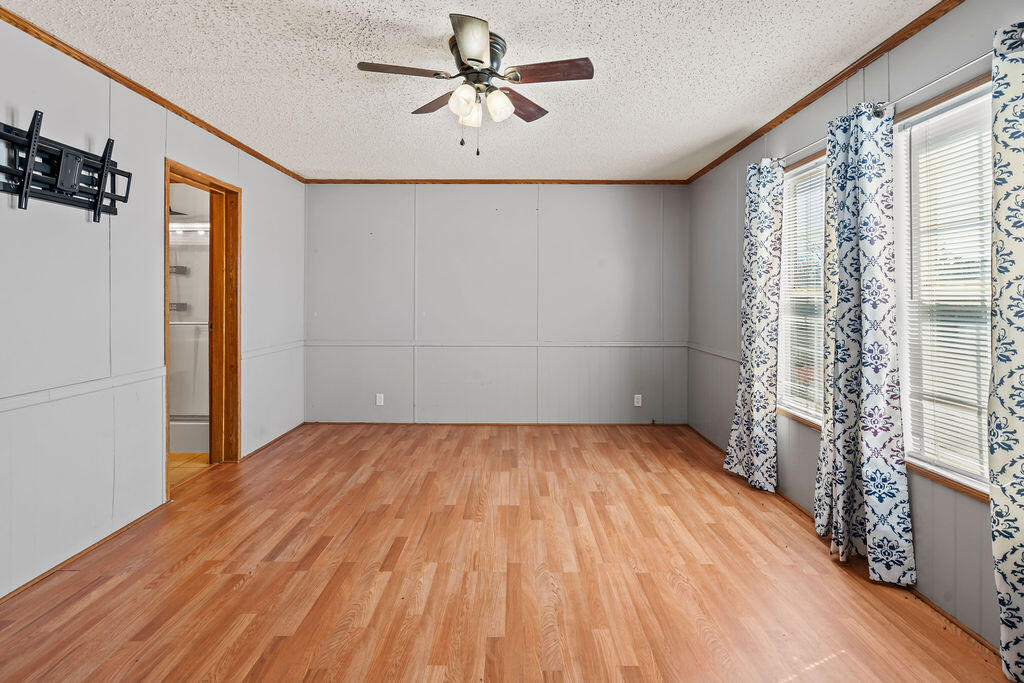 18097 Country Cross Road Florala, AL 36442 - Photo 31 of 32 a view of empty room with wooden floor and fan