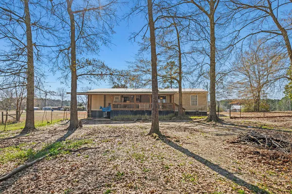 a view of a yard with wooden fence and a bench