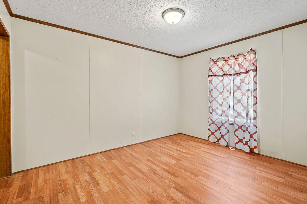 18097 Country Cross Road Florala, AL 36442 - Photo 8 of 32 a view of an empty room with a window and a shower curtain