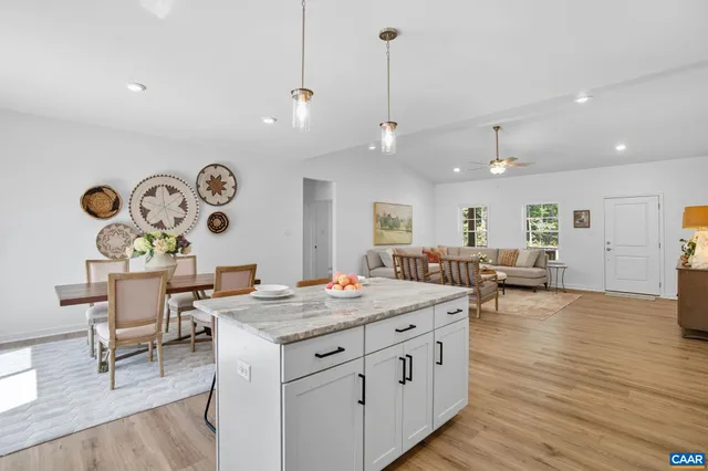 a living room with furniture potted plant and a window