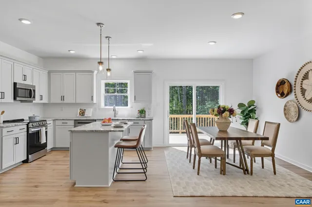 a view of a dining room with furniture and a window