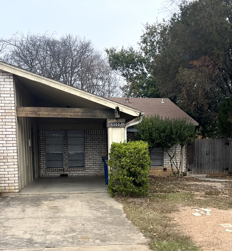 5302 Indio Circle, Unit A Austin, TX 78745 - Photo 1 of 1 a view of a house with a garage and a yard
