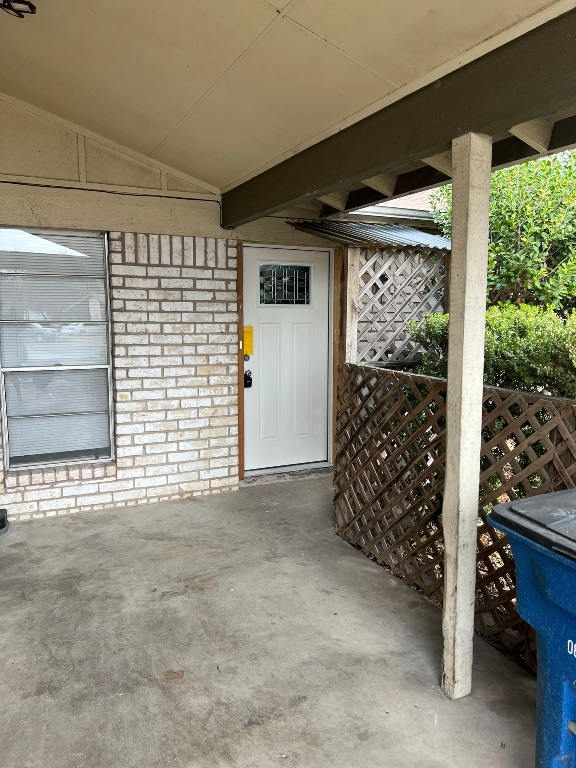 5302 Indio Circle, Unit A Austin, TX 78745 - Photo 2 of 13 Doorway to property with brick siding