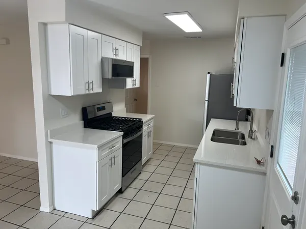 a kitchen with a stove and a microwave