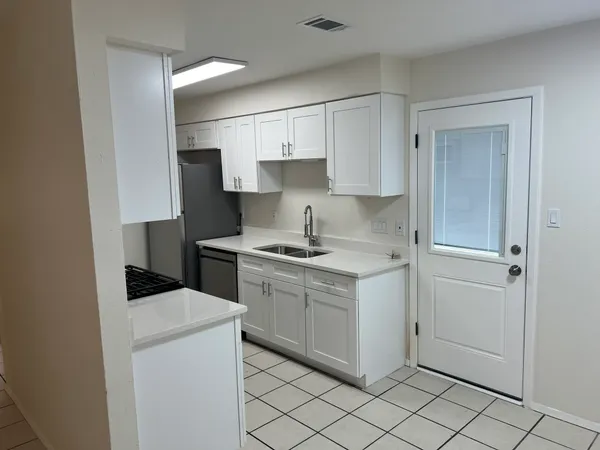 a kitchen with a sink cabinets and appliances