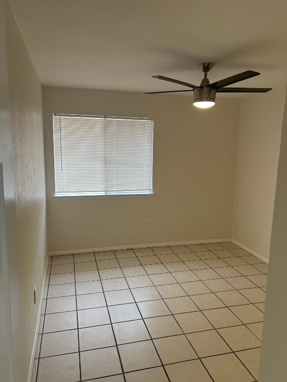 5302 Indio Circle, Unit A Austin, TX 78745 - Photo 8 of 13 Unfurnished room with light tile patterned flooring and ceiling fan