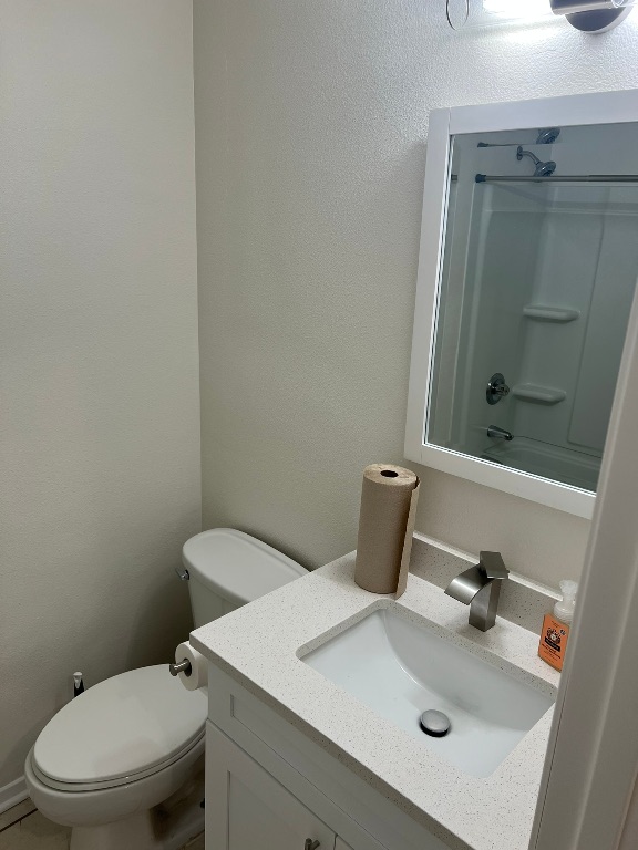 5302 Indio Circle, Unit A Austin, TX 78745 - Photo 10 of 13 Bathroom featuring vanity, shower combination, and a textured wall