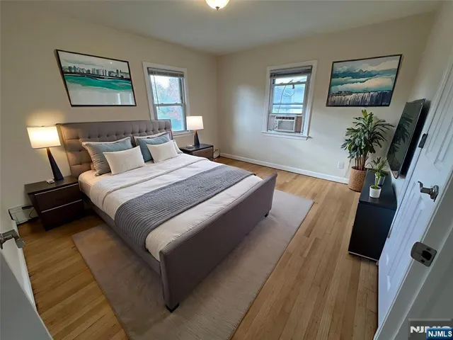 a bedroom with bed and a flat screen tv