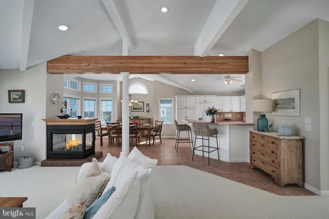a living room with furniture a chandelier and fireplace