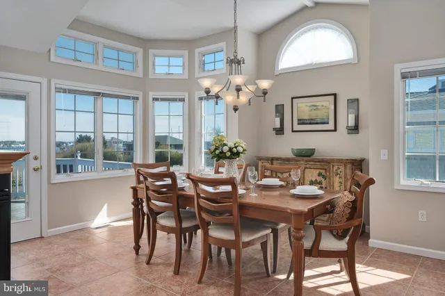 a dining room with furniture a painting and a chandelier