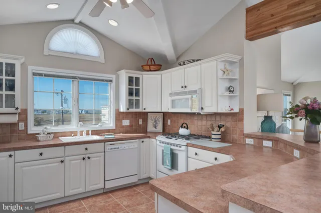 a kitchen with cabinets a sink and appliances