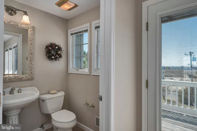 a white toilet sitting next to a bathroom sink
