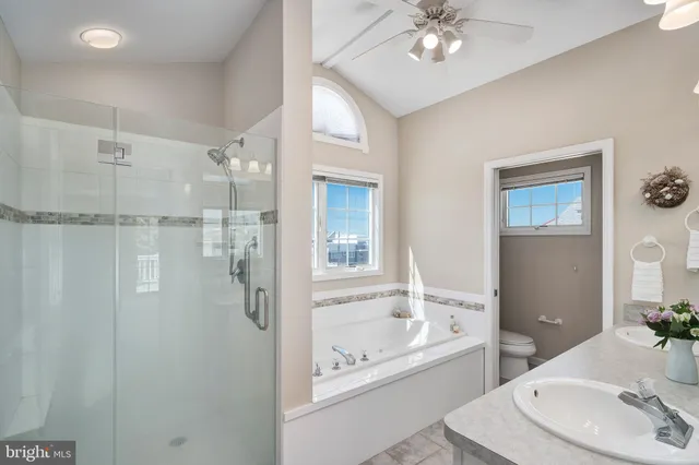 a bathroom with a bathtub shower sink and mirror