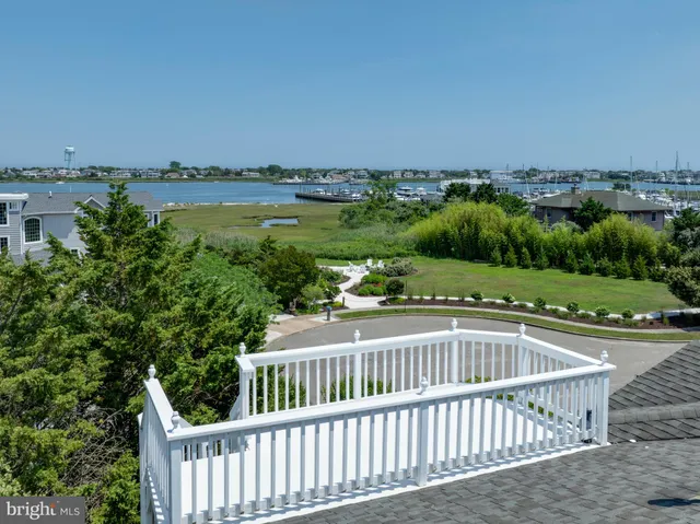 a balcony with wooden floor and city view