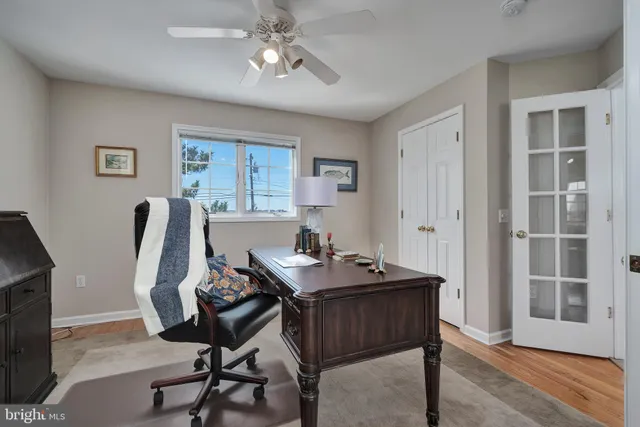 a view of a workspace with furniture and a window