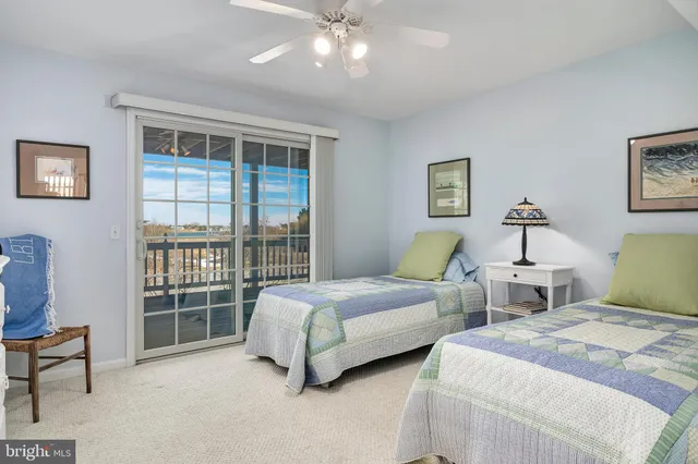 a spacious bedroom with two beds and a window