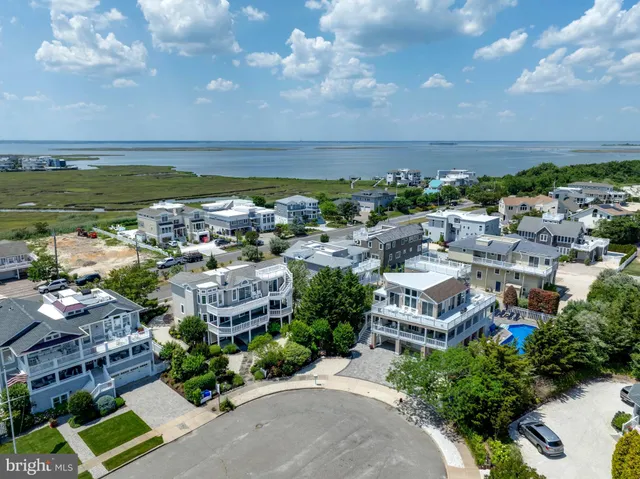 a view of a city with lots of residential buildings ocean and mountain view in back