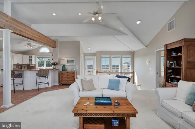 a living room with furniture and kitchen view