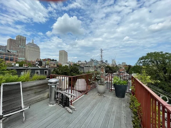 a terrace with outdoor seating and city view
