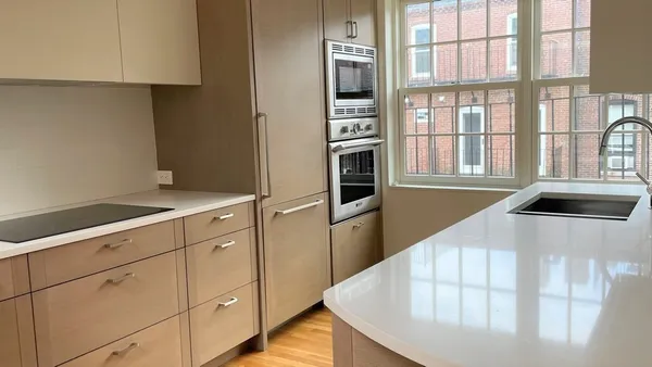 a kitchen with stainless steel appliances kitchen island a refrigerator sink and cabinets