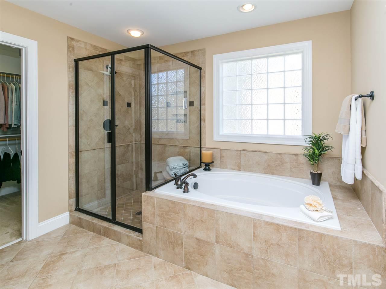 1348 Ileagnes Road Raleigh, NC 27603 - Photo 11 of 25 a bathroom with a bathtub and a shower