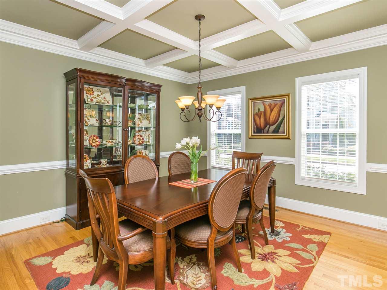 1348 Ileagnes Road Raleigh, NC 27603 - Photo 13 of 25 a dining room with furniture a chandelier and wooden floor