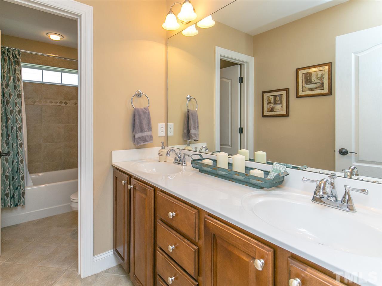 1348 Ileagnes Road Raleigh, NC 27603 - Photo 20 of 25 a bathroom with a sink double vanity and a mirror