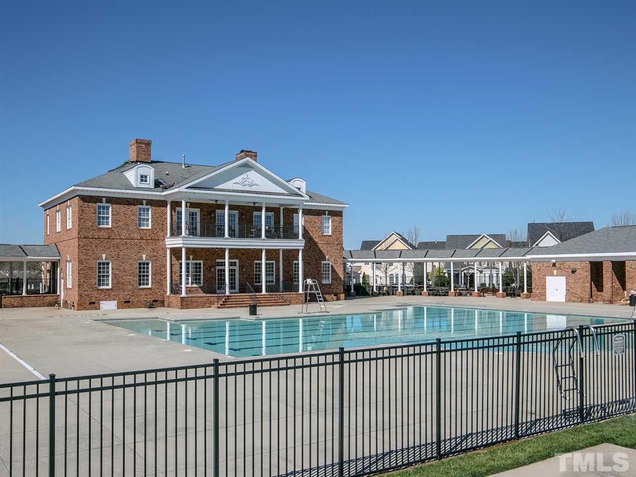 1348 Ileagnes Road Raleigh, NC 27603 - Photo 25 of 25 a front view of a building with glass windows and a yard