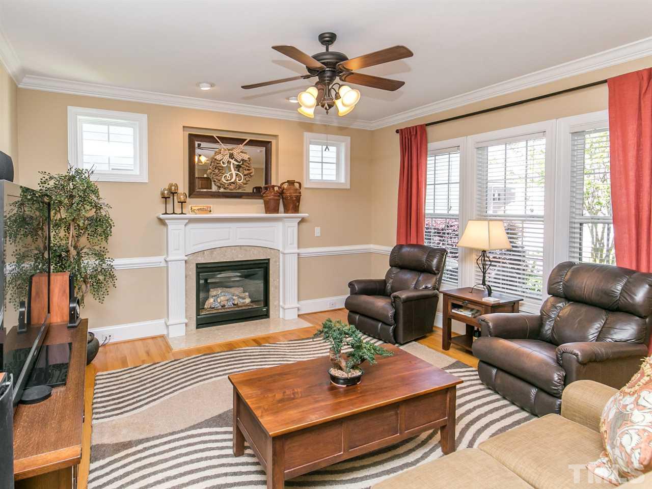 1348 Ileagnes Road Raleigh, NC 27603 - Photo 5 of 25 a living room with furniture a fireplace and windows