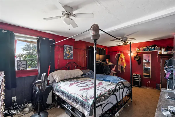 a bed room with a bed and a ceiling fan