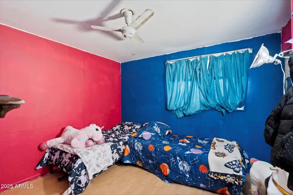 a bed room with a bed and a chair