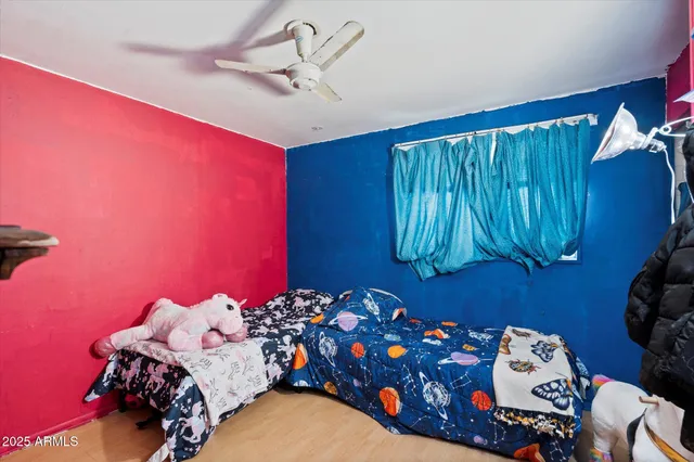 a bed room with a bed and a chair