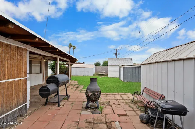 a building outdoor space with patio furniture and potted plants