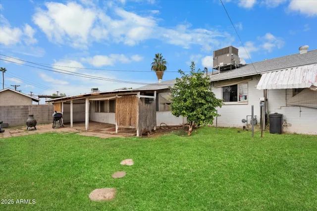 a front view of house with yard and outdoor seating